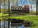Welcome to this charming English Tudor home, nestled in tranquil for sale in South Lyon Michigan Oakland County County on GolfHomes.com