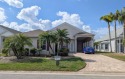 This beautiful home features a 14'x50'x13' RV port with 12k watt for sale in Titusville Florida Brevard County County on GolfHomes.com