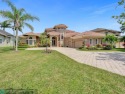 Price Improvement! MAGNIFICENT CUSTOM POOL HOME ON LARGE WATER for sale in Parkland Florida Broward County County on GolfHomes.com