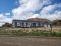 Check out the sweeping views of the golf course and Wind River for sale in Dubois Wyoming Fremont County County on GolfHomes.com