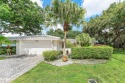 Set on a quiet tree-lined lot in Hampshire at Hunters Run for sale in Boynton Beach Florida Palm Beach County County on GolfHomes.com