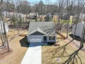 Step into this modern beauty, like-new built in 2022 and nestled for sale in Louisburg North Carolina Franklin County County on GolfHomes.com
