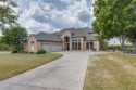 Nestled within the prestigious, gated Eagle Chase community for sale in Pottsboro Texas Grayson County County on GolfHomes.com