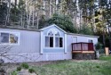 This three-bedroom, two-bath doublewide manufactured home sits for sale in Gold Beach Oregon Curry County County on GolfHomes.com