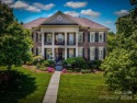 Discover unparalleled luxury in this all-brick, 5 bed/5 bath for sale in Huntersville North Carolina Mecklenburg County County on GolfHomes.com