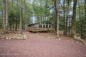 Let the outside in with this beautiful original Lake Naomi cabin for sale in Pocono Pines Pennsylvania Monroe County County on GolfHomes.com