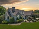 Overlooking manicured fairways and a sparkling lake, this home for sale in Woodstock Georgia Cherokee County County on GolfHomes.com