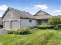 Enjoy low-maintenance living with beautiful golf course views in for sale in Traverse City Michigan Grand Traverse County County on GolfHomes.com