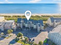 Introducing this top-floor oceanfront stunner, fully furnished for sale in Oak Island North Carolina Brunswick County County on GolfHomes.com