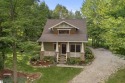 Experience year-round comfort and elegance in this like-new for sale in Thompsonville Michigan Benzie County County on GolfHomes.com