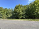 This 1.12-acre parcel features mature hardwoods and a gentle for sale in Cedar Michigan Leelanau County County on GolfHomes.com