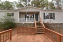 Situated on roughly 5.5 acres, this mobile home offers ample, Arkansas