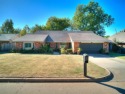 Large brick home backing up to Surrey Hills Golf Club! This 3 for sale in Yukon Oklahoma Canadian County County on GolfHomes.com