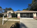 Exquisite custom home showcasing a generous living room, formal for sale in Citrus Springs Florida Citrus County County on GolfHomes.com