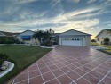 This stunning home offers unparalleled views of a tranquil lake for sale in Sun City Center Florida Hillsborough County County on GolfHomes.com