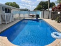 Charming one story 3-bedroom, 2-bathroom pool home with a 2-car for sale in Sunrise Florida Broward County County on GolfHomes.com