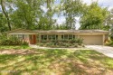 Nestled within a canopy of lush trees, this charming 1960s home for sale in Jacksonville Florida Duval County County on GolfHomes.com