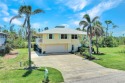 Combining classic Florida luxury with tranquil island style for sale in Bokeelia Florida Lee County County on GolfHomes.com