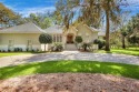 MUST SEE this beautiful Southern-style home with a circular for sale in Saint Simons Georgia Glynn County County on GolfHomes.com