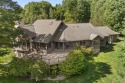 Custom-designed cedar home on over 7.5 acres with 600' of for sale in Bear Lake Michigan Manistee County County on GolfHomes.com