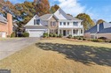Beautiful traditional-style home with a rocking chair front for sale in Suwanee Georgia Forsyth County County on GolfHomes.com