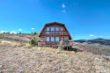 Rustic modified A-frame cabin on 2.9 acres with panoramic views for sale in Garden City Utah Rich County County on GolfHomes.com