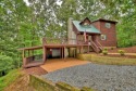 Mountain home with beautiful oversized windows bringing in an for sale in Ellijay Georgia Gilmer County County on GolfHomes.com