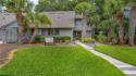 Magnolias, Palm trees and impeccable landscaping frame the for sale in Hilton Head Island South Carolina Beaufort County County on GolfHomes.com