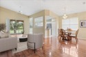 Enjoy sweeping views of Arrowhead Golf Course from this rare for sale in Naples Florida Collier County County on GolfHomes.com