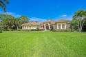 Perched on a one-acre lot along the 6th hole, this stunning for sale in Palm City Florida Martin County County on GolfHomes.com