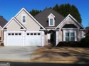 THIS BEAUTIFUL 1.5 STORY STUCCO HOME BEHIND THE GATES OF THE for sale in Stockbridge Georgia Henry County County on GolfHomes.com