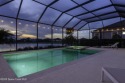 Enjoy lake views and vibrant sunsets from your gas-heated pool for sale in Melbourne Florida Brevard County County on GolfHomes.com