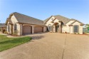 Luxury home with curb appeal is on the 14th hole of Harbor Lakes for sale in Granbury Texas Hood County County on GolfHomes.com
