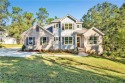 Nestled on nearly  3/4  of an acre, this stunning 4-bedroom, 3 for sale in Fairhope Alabama Baldwin County County on GolfHomes.com