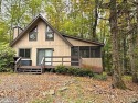 This simply sweet chalet getaway is nestled on a pretty forested for sale in Hamlin Pennsylvania Wayne County County on GolfHomes.com