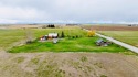 A log-style residence sits on the peaceful plains of central for sale in Choteau Montana Teton County County on GolfHomes.com