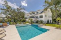 Embrace the timeless elegance of coastal Southern living in this for sale in Saint Simons Georgia Glynn County County on GolfHomes.com