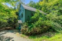 Tucked at the end of a quiet cul-de-sac, this post-and-beam cape for sale in Grantham New Hampshire Sullivan County County on GolfHomes.com