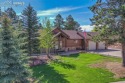 Amazing custom log-sided home backing to beautiful Shining Mtn for sale in Woodland Park Colorado Teller County County on GolfHomes.com