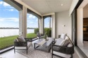 Experience elevated lakeside living in this beautifully for sale in Miromar Lakes Florida Lee County County on GolfHomes.com