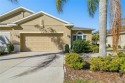THIS HOME IS A WOW!!  Entering through a screened entry and a for sale in Sun City Center Florida Hillsborough County County on GolfHomes.com
