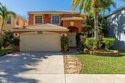 Beautifully maintained 4-bedroom, 2.5-bath home with a 2-car for sale in Royal Palm Beach Florida Palm Beach County County on GolfHomes.com