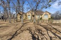 Poised beneath a canopy of mature trees on a gorgeous one-acre for sale in Lipan Texas Parker County County on GolfHomes.com