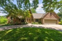 Welcome to this stunning 1.5-story Tudor-style home nestled on for sale in Leawood Kansas Johnson County County on GolfHomes.com