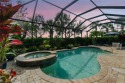 Priced Under Appraisal Value! Tucked behind lush tropical for sale in Naples Florida Collier County County on GolfHomes.com