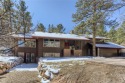 A Perry Park classic! This beautiful tri-level sanctuary is for sale in Larkspur Colorado Douglas County County on GolfHomes.com