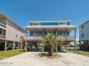 This 4 bedroom, 2 bath, 1.5 story beach house comes fully for sale in Oak Island North Carolina Brunswick County County on GolfHomes.com