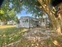 This 2BR/2BA cottage style double-wide in a fabulous country for sale in Fort Pierce Florida Saint Lucie County County on GolfHomes.com