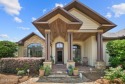 Nestled in a serene setting with views of a pond and golf course for sale in Panama City Florida Bay County County on GolfHomes.com