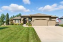 Step into luxury with this stunning reverse 1 1/2 -story home for sale in Olathe Kansas Johnson County County on GolfHomes.com